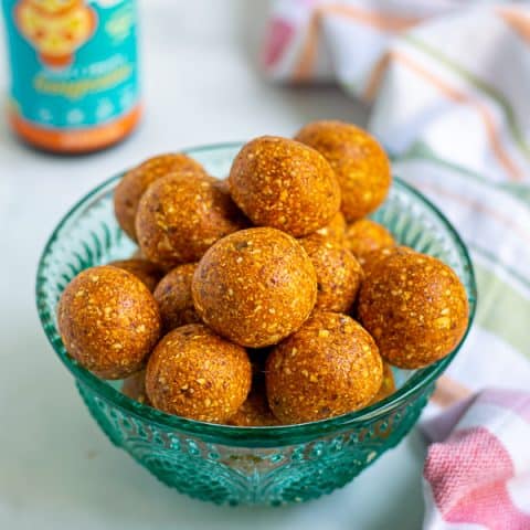 a blue bowl full of easy tropical energy bites