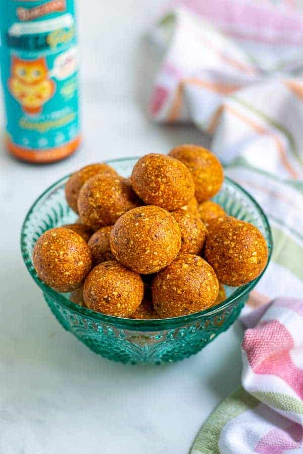a blue bowl full of easy tropical energy bites