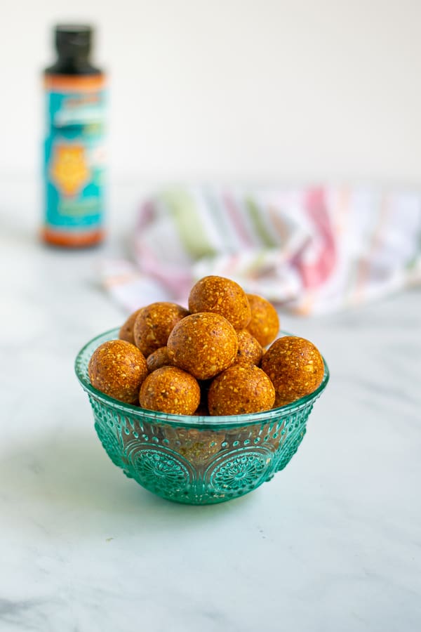 tangerine tropical energy bites in a blue bowl