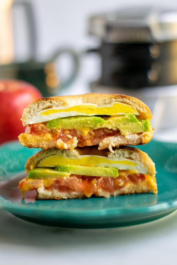 cut open avocado breakfast sandwich revealing the sandwich insides