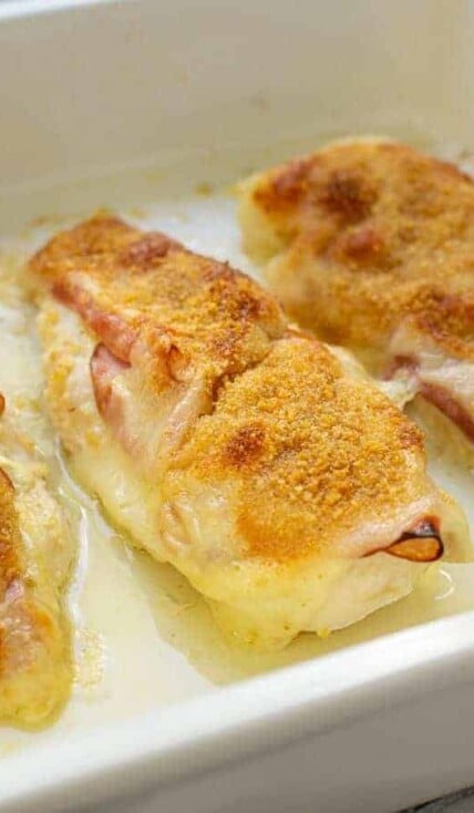 Close up of a chicken cordon bleu baked chicken in a casserole dish.