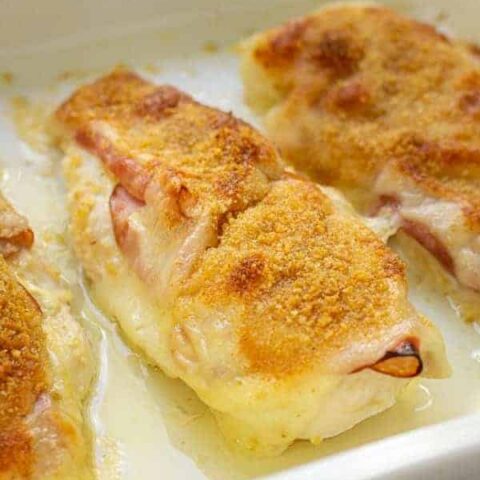 Close up of a chicken cordon bleu baked chicken in a casserole dish.