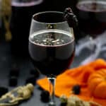 wine glass full of spooky black sangria