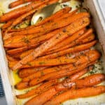 white dish full of dill roasted carrots