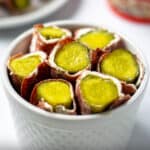 dried beef pickle roll ups in a white bowl with cream cheese
