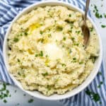 large white bowl of garlic herb pressure cooker mashed potatoes