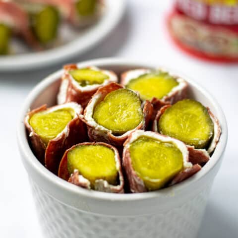 white bowl full of dried beef pickle roll ups
