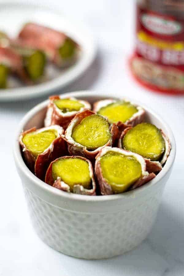 white bowl full of dried beef pickle roll ups