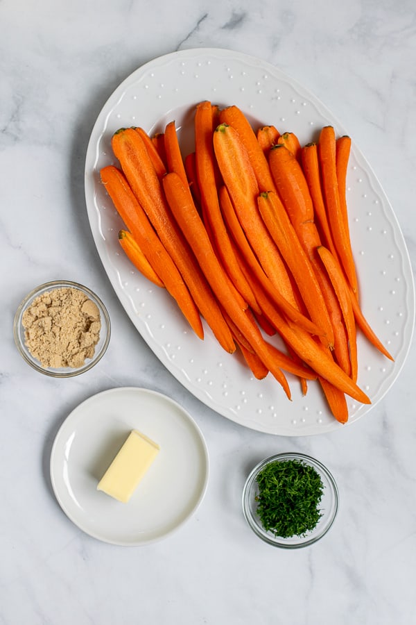 carrots halved, brown sugar, butter, and fresh dill are all the ingredients needed to make these roasted carrots