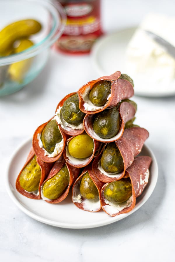 tall stack of dried beef pickle roll ups on a white plate