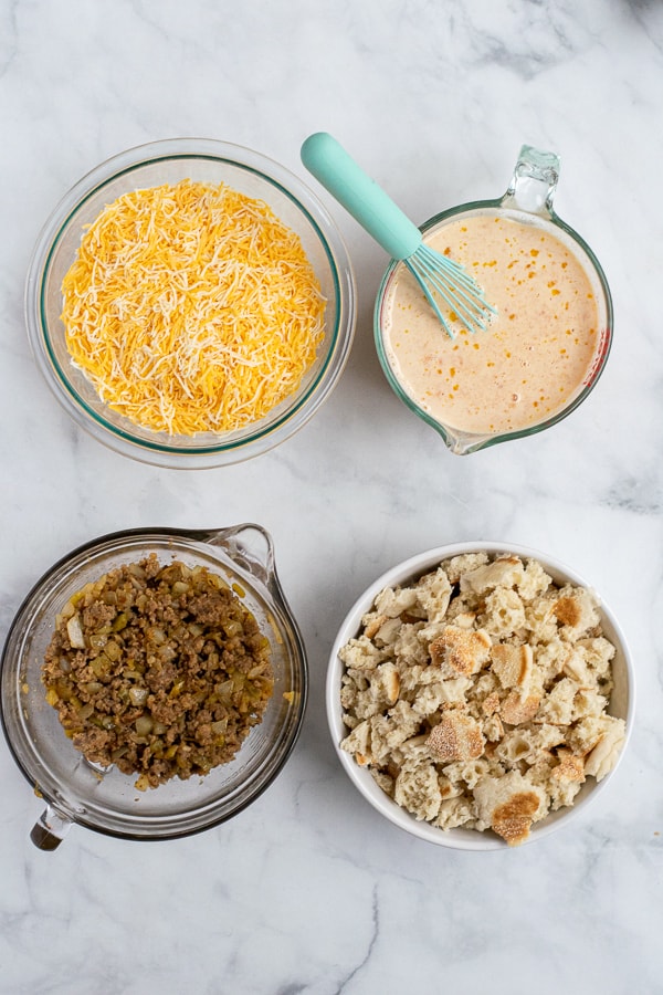 4 bowls of the prepped layers of breakfast casserole
