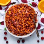 cranberry relish with orange and apple in a white bowl