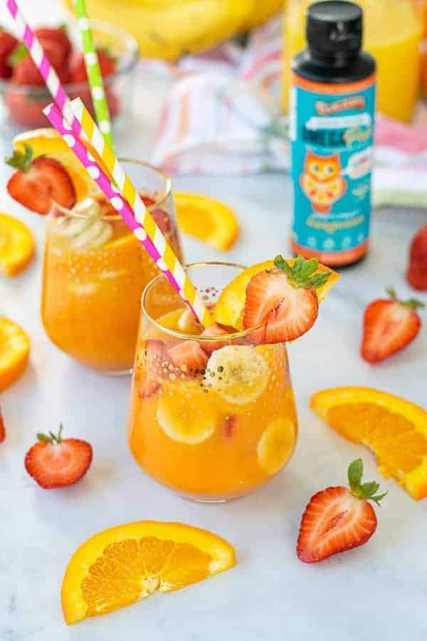 large glass of breakfast mocktail filled with fruits