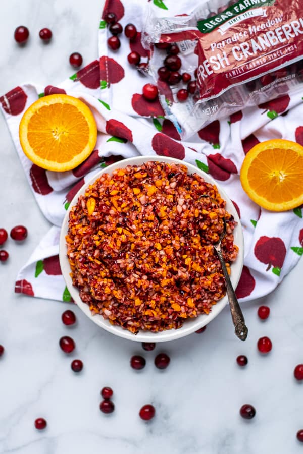 flatly of a bowl of cranberry orange relish with cranberries and oranges