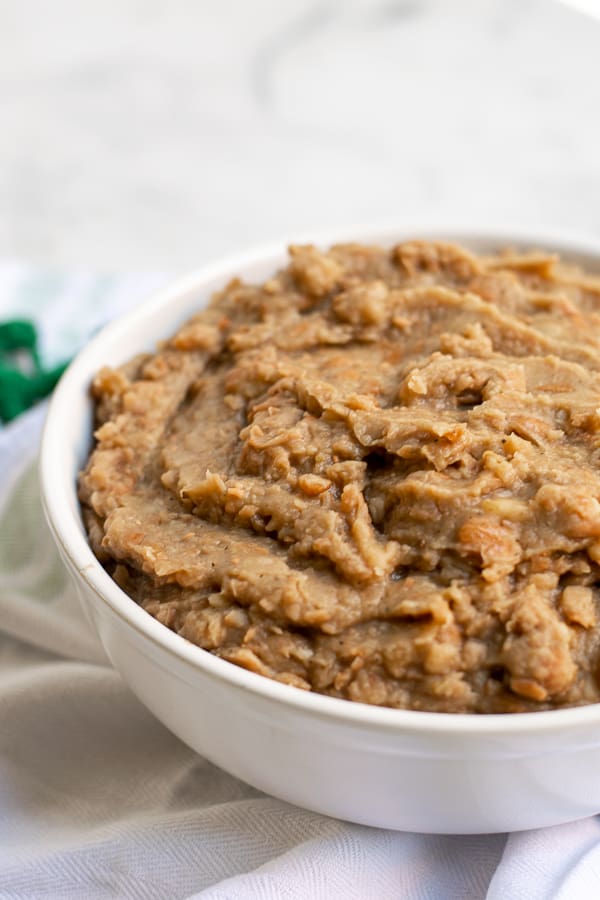 refried beans freshly mashed in a white bowl