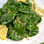 healthy simple spinach salad on a large white platter