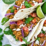 vegetarian red lentil tacos filled with garnishes are an easy weeknight meal