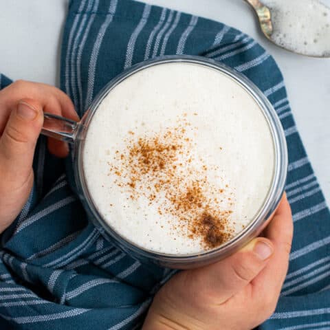 overhead shot of kid friendly latte with toddler hands