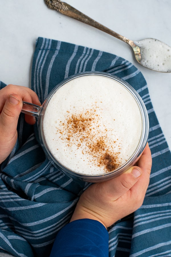 overhead shot of kid friendly latte with toddler hands