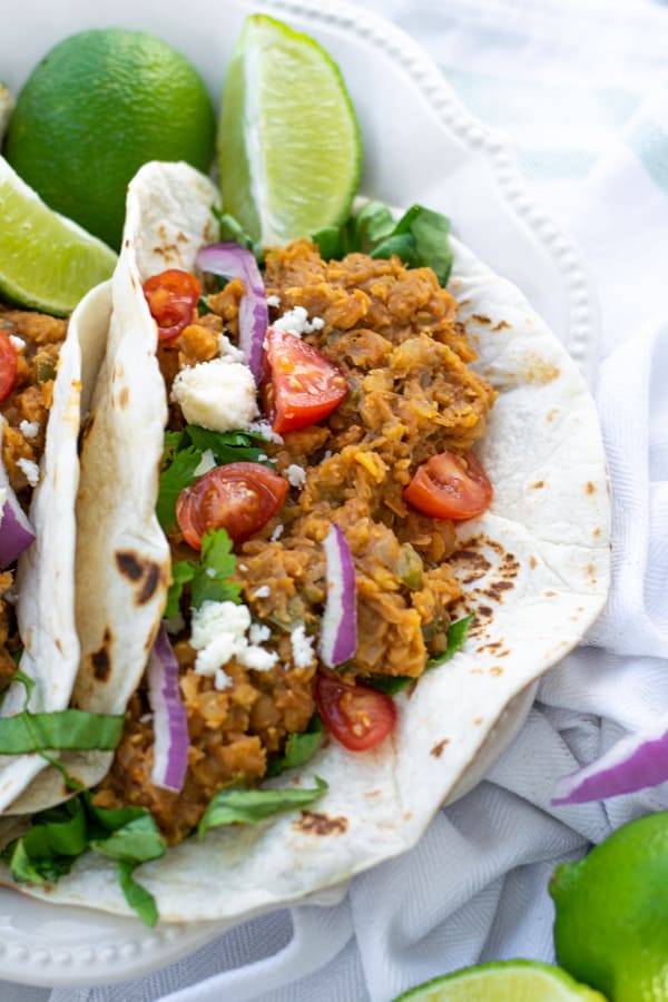 red lentil taco filling in a flour tortilla