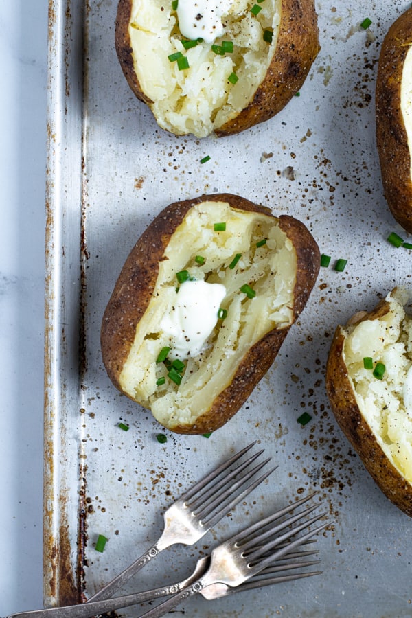 pressure cooker baked potatoes on a tray after getting crispy under the broiler