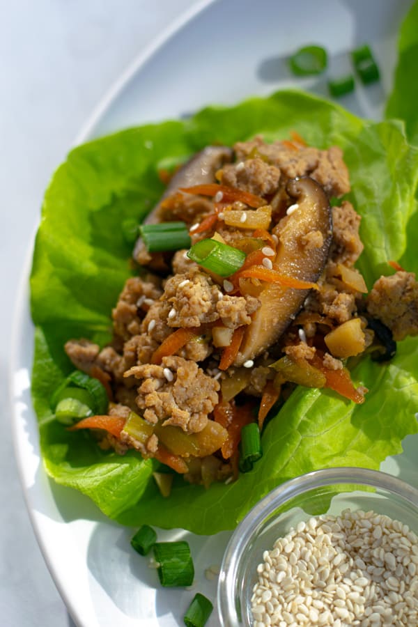 close up of the chicken filling on a lettuce wrap on a plate