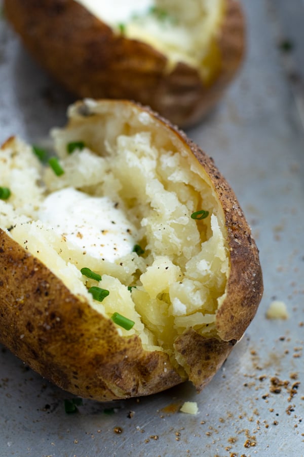 Baked Potato made in the pressure cooker sliced open revealing fluffy perfectly cooked inside
