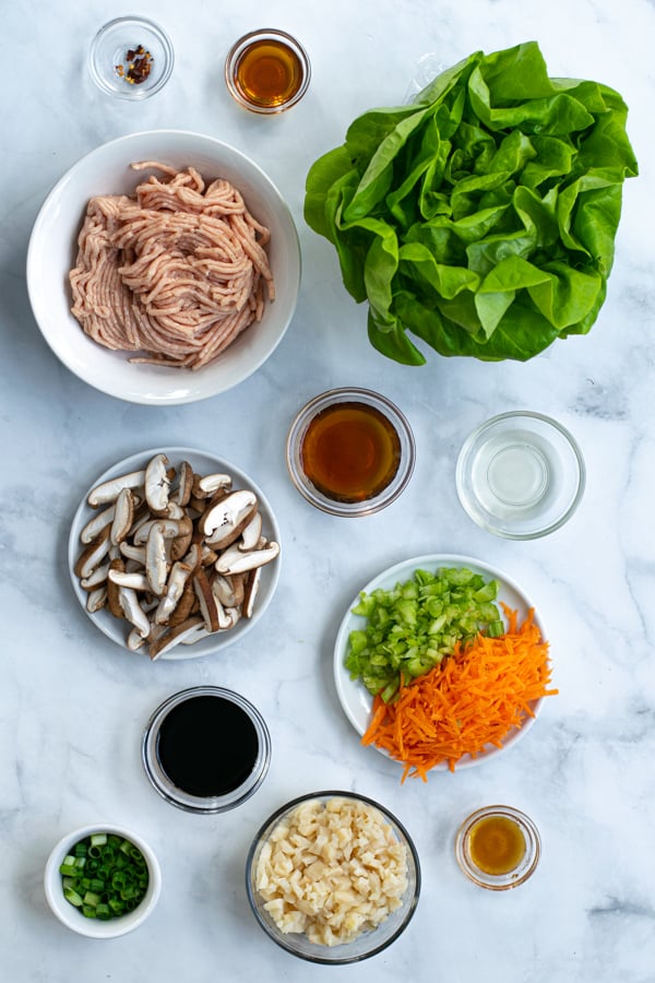 ingredients needed for asian chicken wraps including ground chicken, Bibb lettuce, and sauces