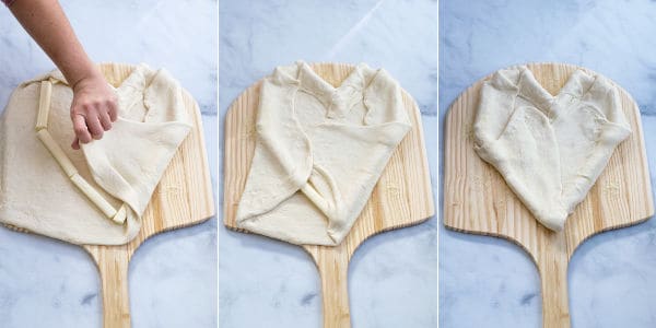 dough being folded over string cheese to make the heart shaped stuff crust pizza