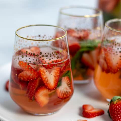 glasses of strawberry sangria with heart shaped strawberries and basil perfect for Valentine's Day, brunches, and bridal showers