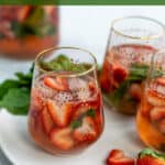 pinterest pin for strawberry sangria with glasses of pink sangria on a plate