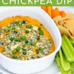 easy Buffalo Chickpea Dip in a small white baking dish with blue cheese and green onions with chips and vegetables for serving with Pinterest text