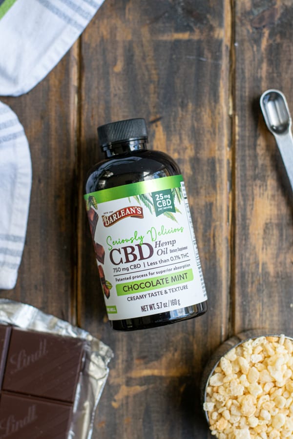 a bottle of Seriously Delicious Chocolate Mint CBD hemp oil on a wooden table