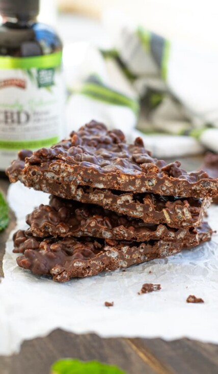 Chocolate Mint Crunch Bar broken into pieces and stacked to show the crispy inside