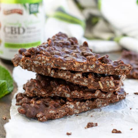Chocolate Mint Crunch Bar broken into pieces and stacked to show the crispy inside