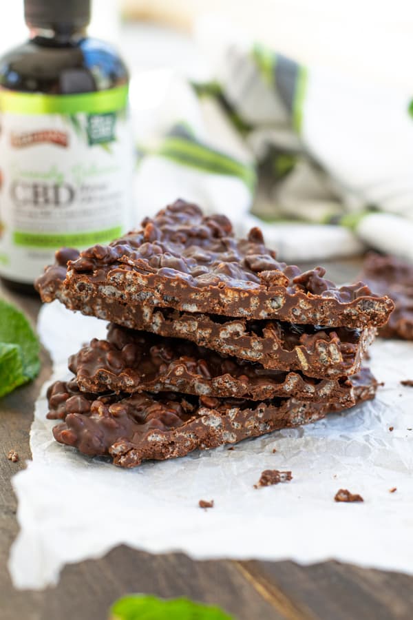 Chocolate Mint Crunch Bar broken into pieces and stacked to show the crispy inside
