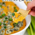Warm Buffalo Chickpea Dip piled high on a tortilla chip