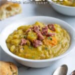 a white bowl full of split pea soup with the title ' pressure cooker split pea soup'