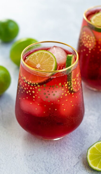 Hibiscus Iced Tea Sparkler in a glass with ice and limes