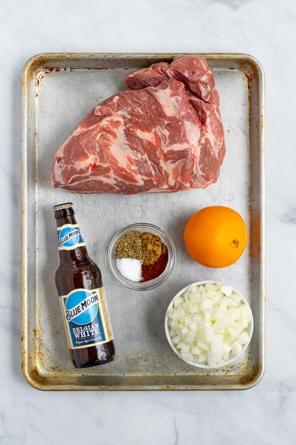 all of the ingredients laid out to make the crockpot carnitas recipe