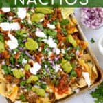 Pork Carnitas Nachos Pinterest Pin with a sheet pan of nachos with cheese and toppings