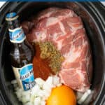 Slow Cooker Carnitas Pinterest Pin showing a crockpot full of the ingredients needed