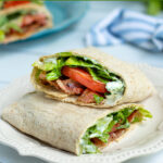 Pinterest Pin for Healthy BLT Wraps showing a picture of a BLT wrap cut open to show off a secret sauce, bacon, lettuce, tomatoes