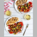 Pinterest Pin for Grilled Chicken Panzanella Salad showing a white plate with a grilled chicken breast and a pile of panzanella salad