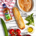ingredients for grilled chicken panzanella salad labeled with arrows on a white background