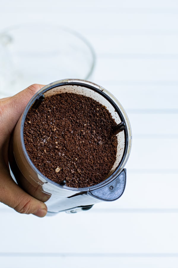 ground coffee in a small black coffee grinder