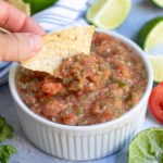 Pinterest Pin for Fresh Restaurant Style Salsa made in a food processor showing a tortilla chip scooping salsa out of a bowl