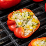 Pinterest Pin for Grilled Stuffed Bell Peppers showing a stuffed red bell pepper on black grill grates