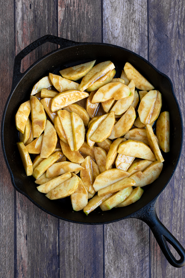 filling and apples spread out in a cast iron pan