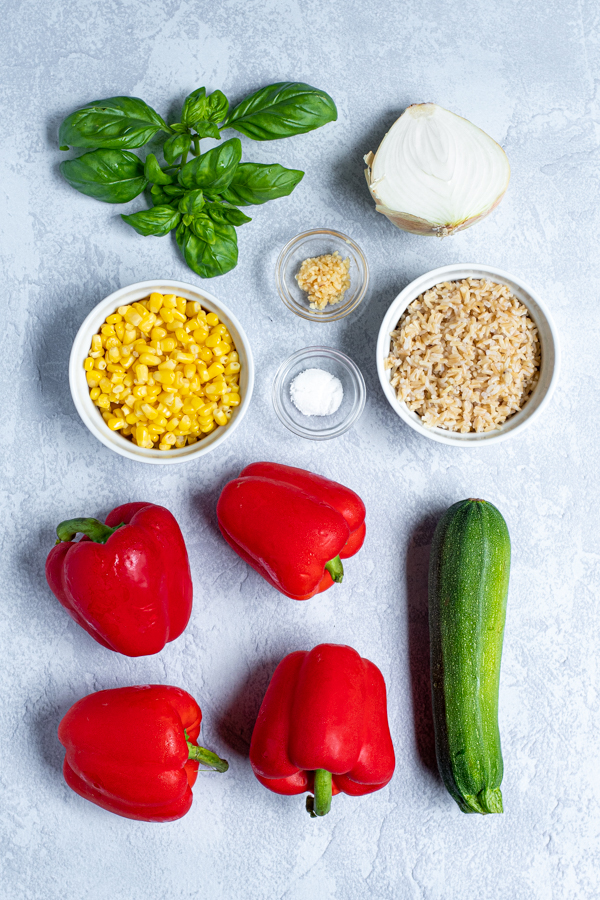 ingredients needed to make stuffed bell peppers laid out on a table top